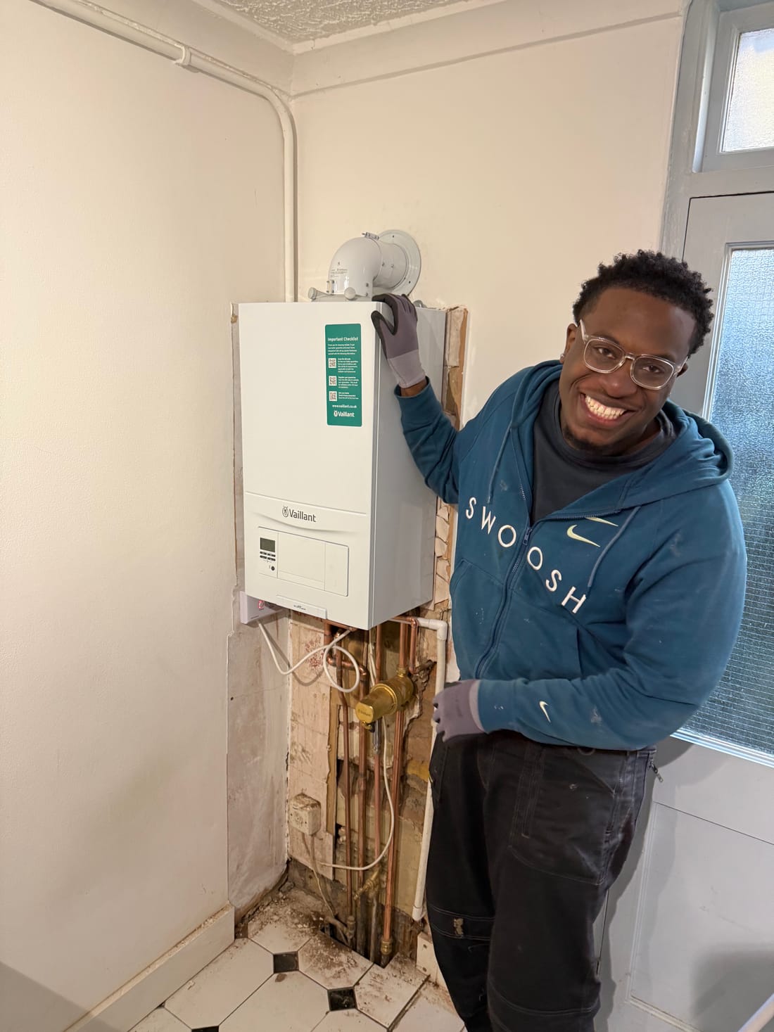 Future Home Energy engineer beside a Vaillant boiler he has just installed