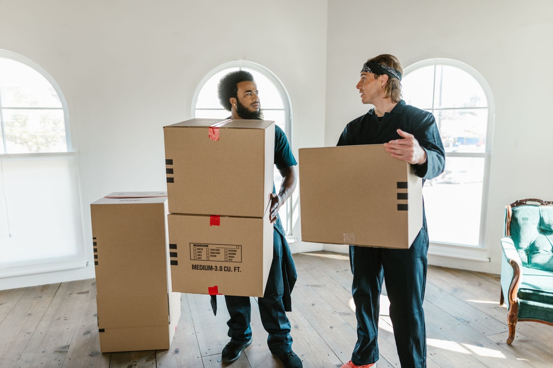 Removals team loading boxes into a van