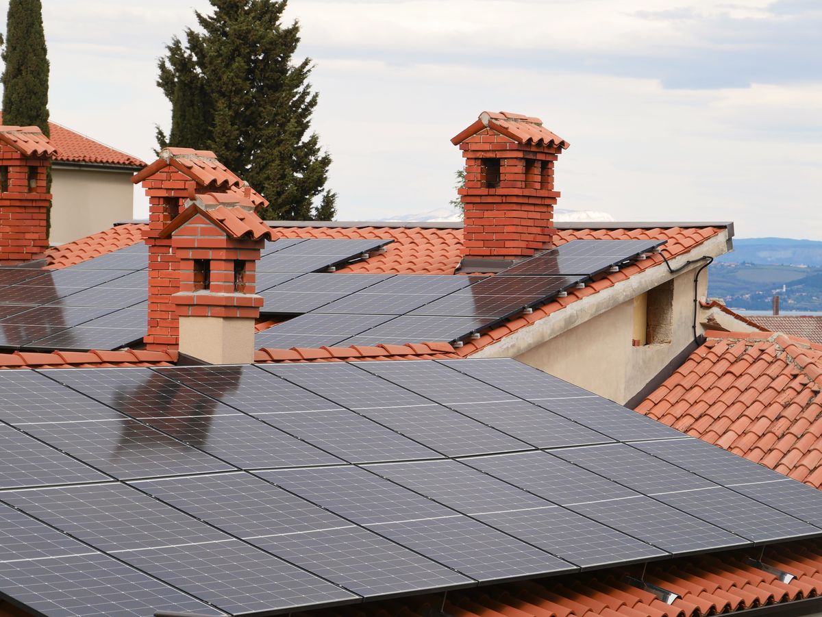 Solar panels installed across the tiled roofs of residential homes