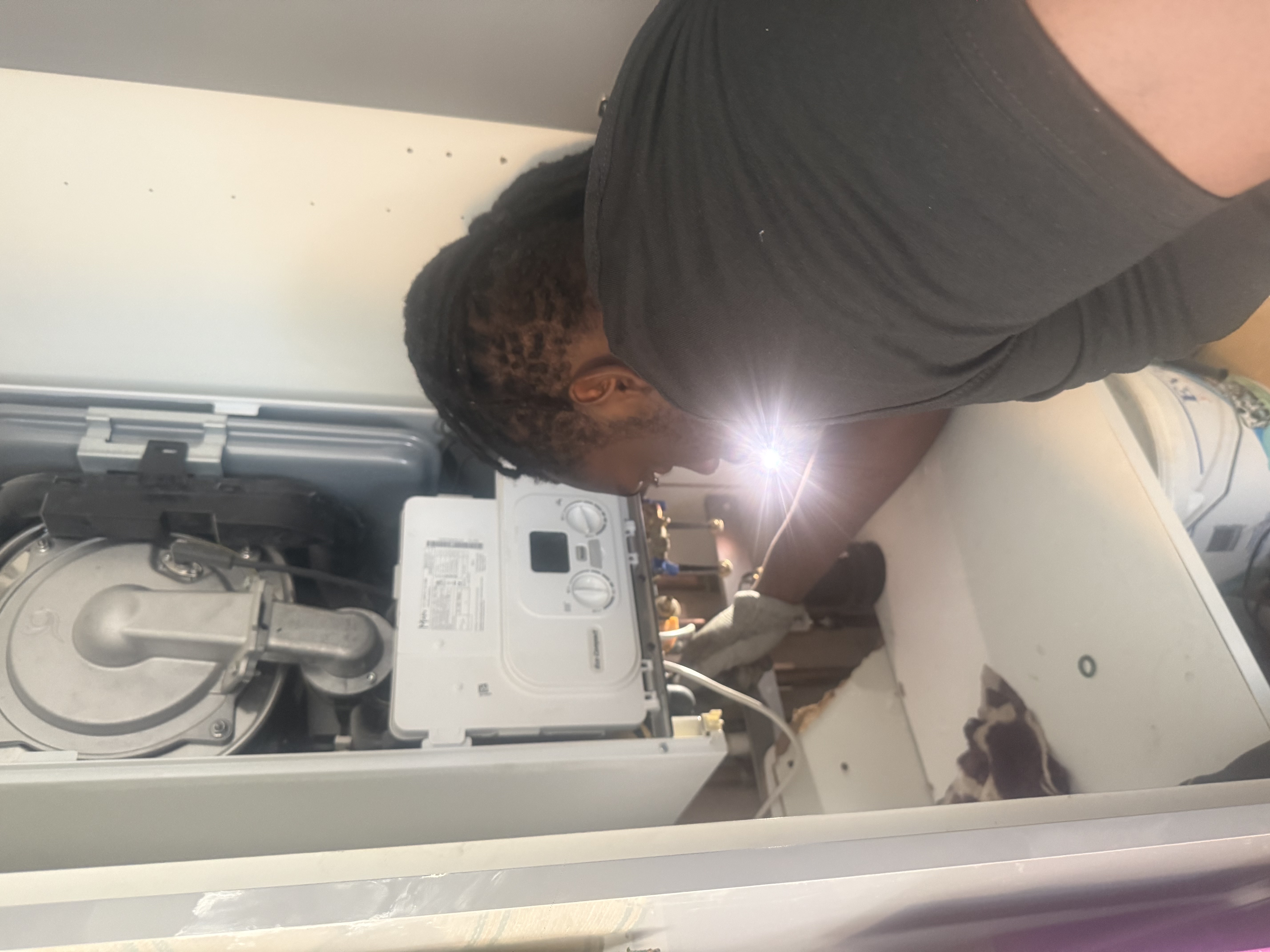 Gas Safe engineer working inside an open Main Eco Compact boiler