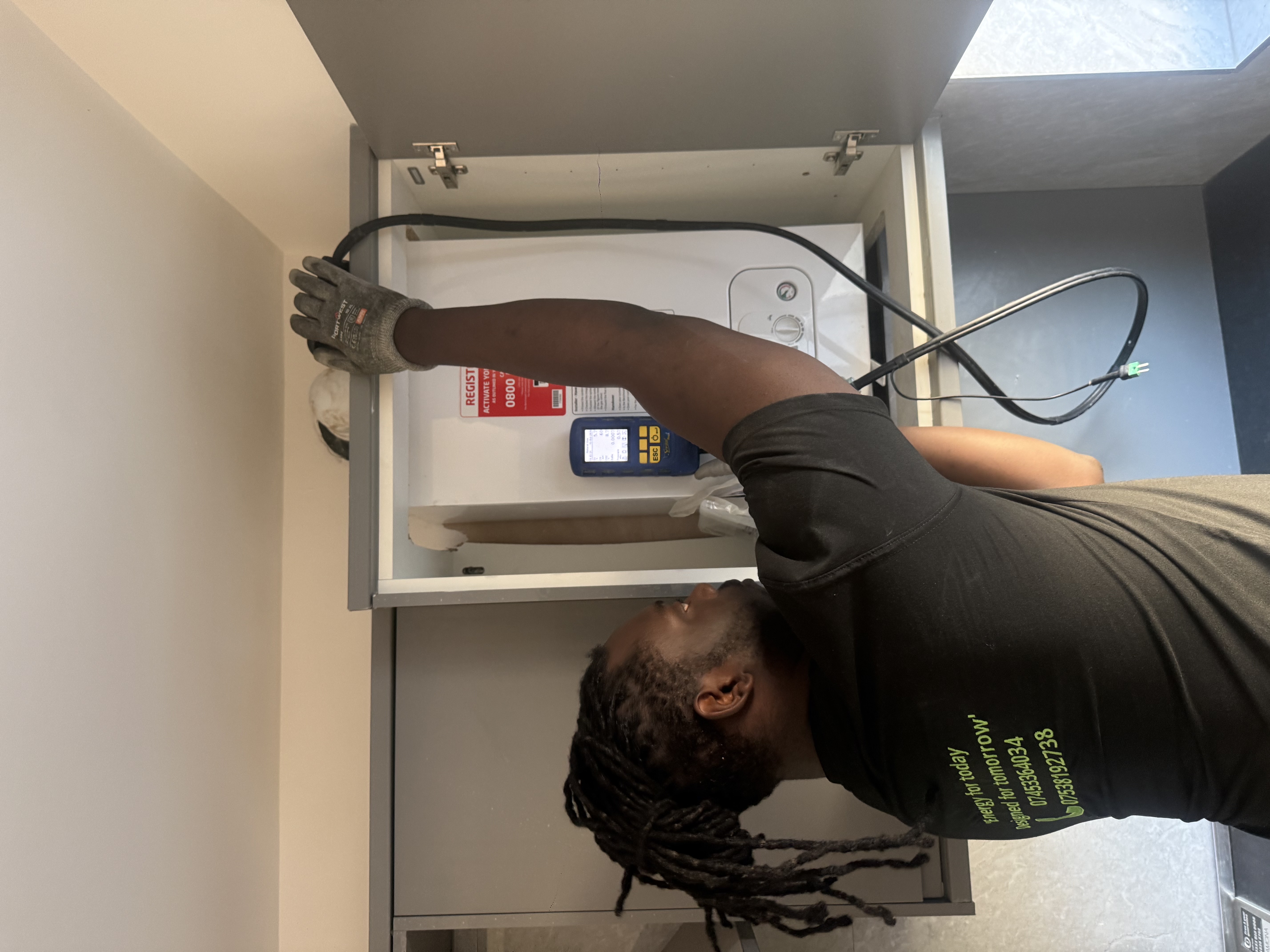 Future Home Energy engineer servicing a boiler inside a cupboard