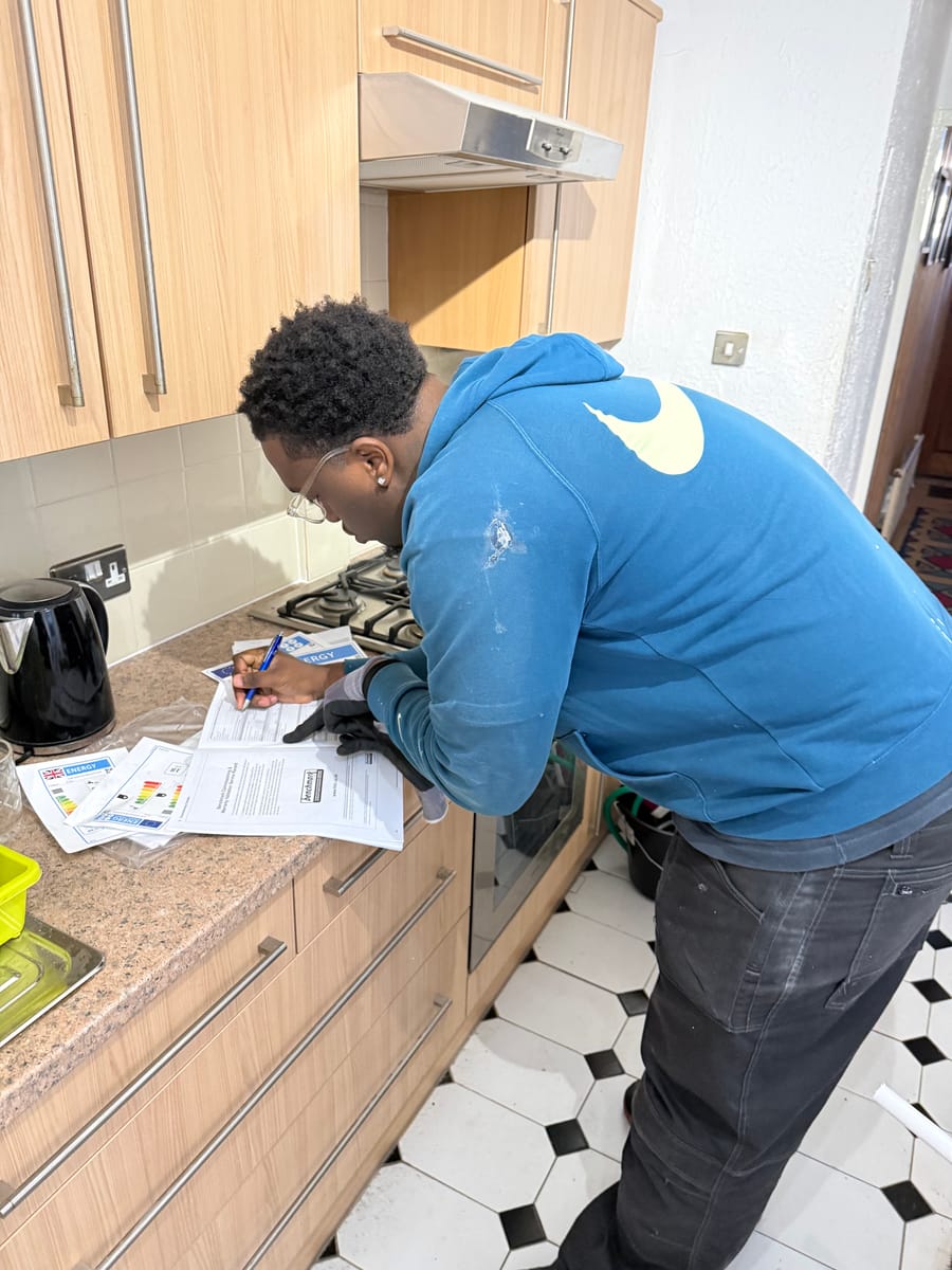 Engineer completing gas safety paperwork after a boiler service