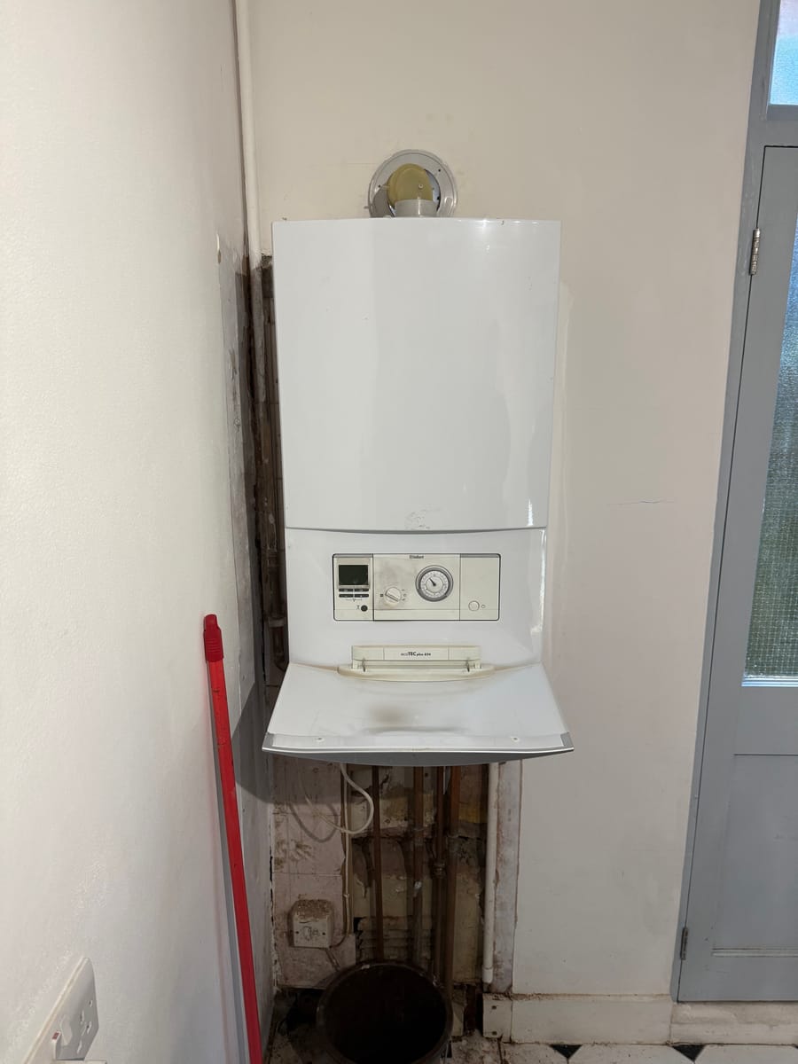 Old wall-mounted boiler in a London home before replacement