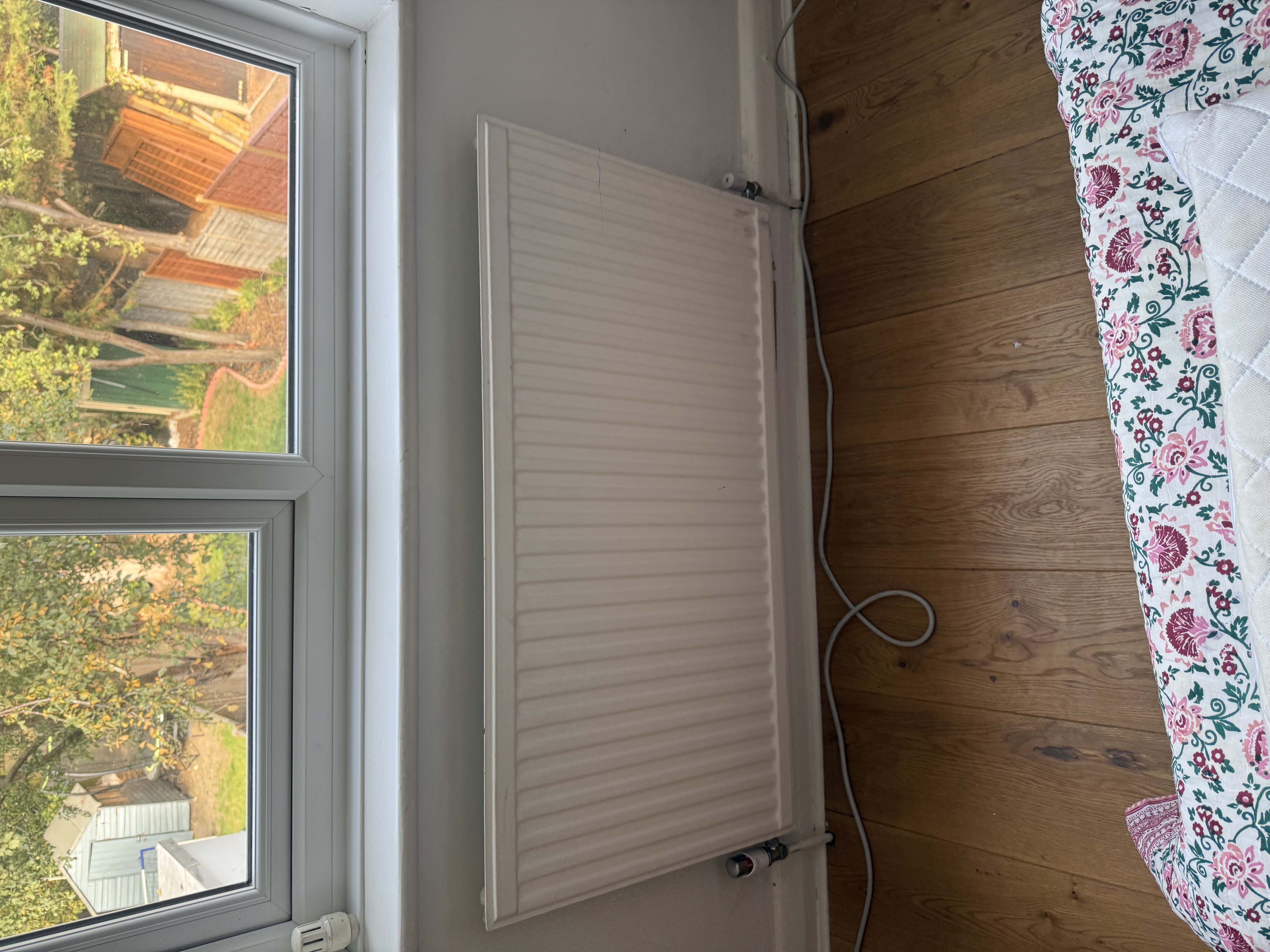 Panel radiator installed beneath a window in a London home